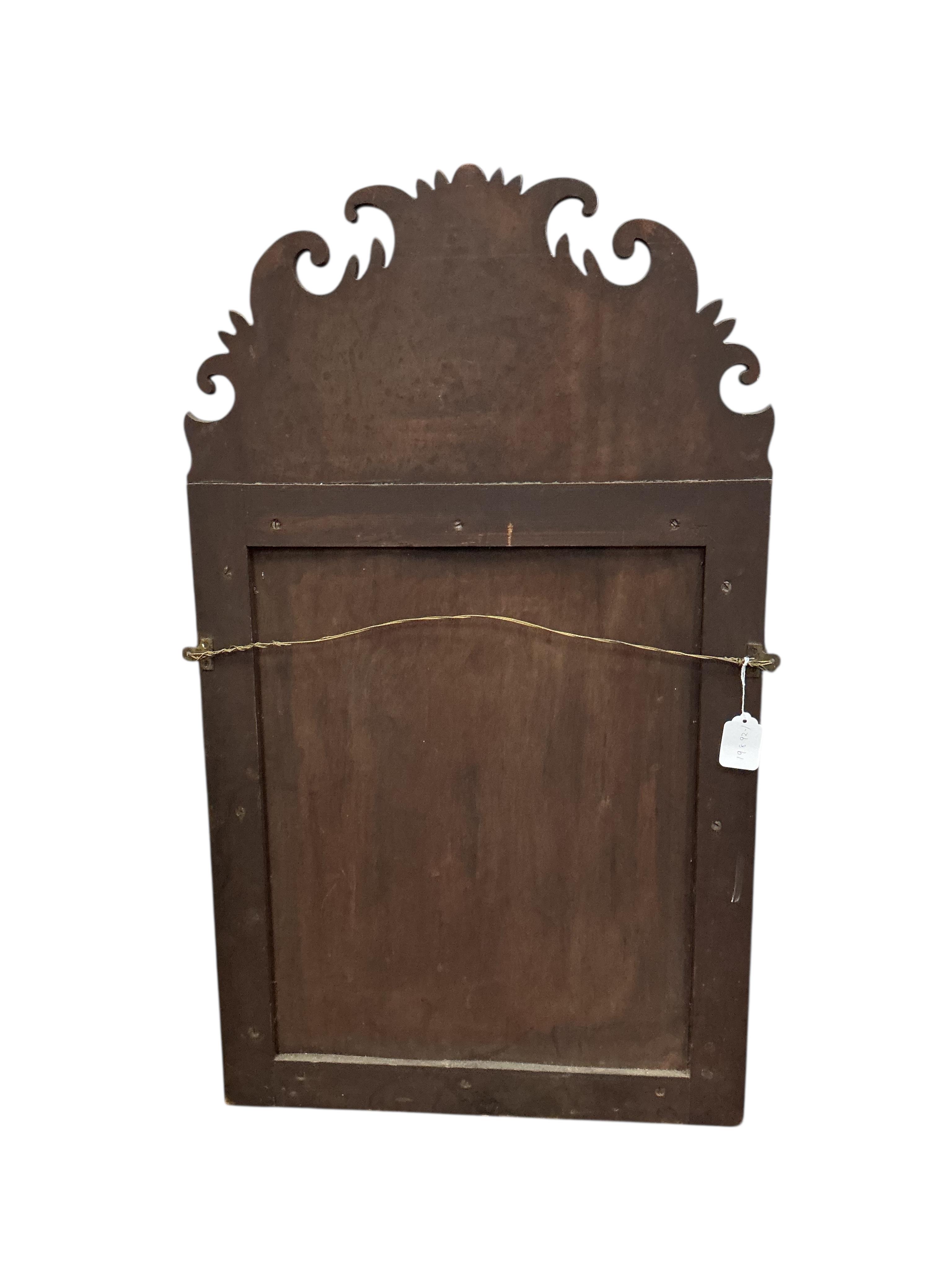 A William and Mary style walnut cushion framed fret cut wall mirror, width 56cm, height 96cm